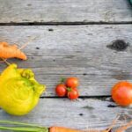 Vibrant vegetable plants thriving in a greenhouse garden, surrounded by lush green foliage