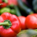 First-grade students enjoy tasting vegetables while gardening together